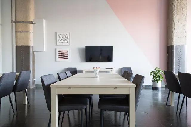 An empty meeting room with a long table