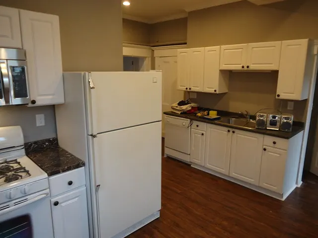 A small kitchen with white cabinets